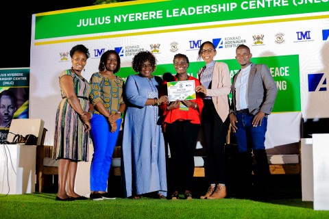 Dr. Nansozi Muwanga, Ms. Angella Kasekende and other officials present a certificate to one of the Student Leaders. Konrad Adenauer Stiftung-Julius Nyerere Leadership Centre (JNLC) Peace and Security Leadership Training for Finalists and Graduating former Student Leaders in Different Universities in Uganda, Day Three, 5th December 2024, JNLC Gardens, Pool Road, Makerere University, Kampala Uganda, East Africa.
